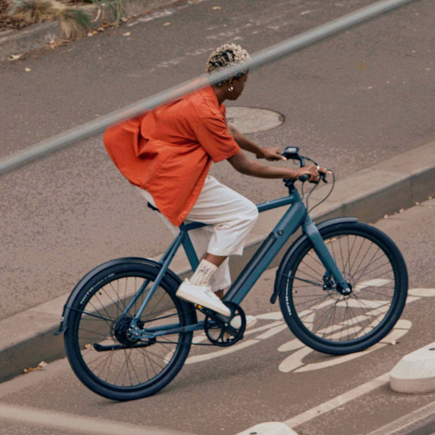 Girl on Amsterdam ebike biking uphill