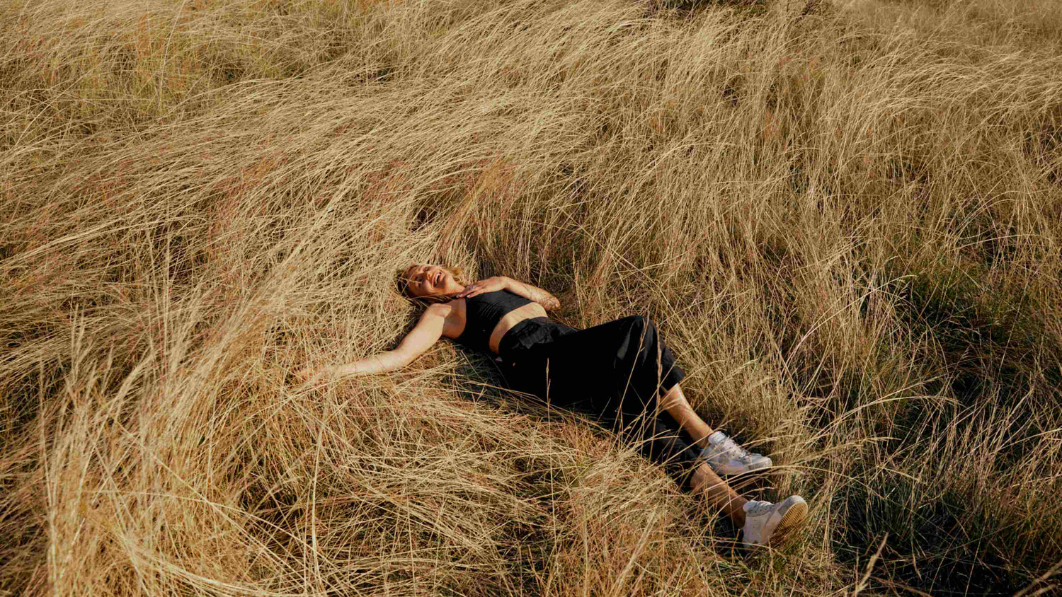 Happy girl laying in field dreaming about Lekker Bikes Happy girl laying in field dreaming about Lekker Bikes